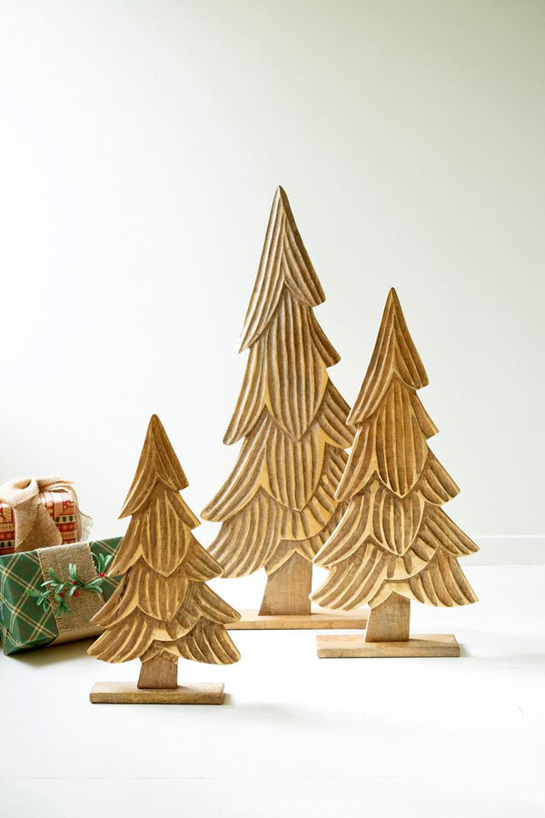 Set of three carved wooden Christmas trees on bases with gold accents