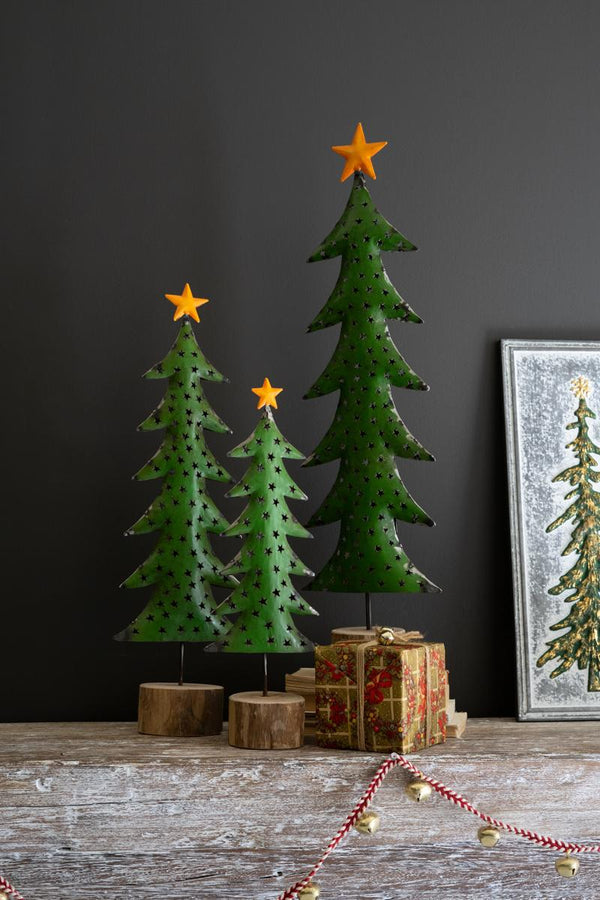 Set of three green recycled metal Christmas trees with gold toppers on wood bases