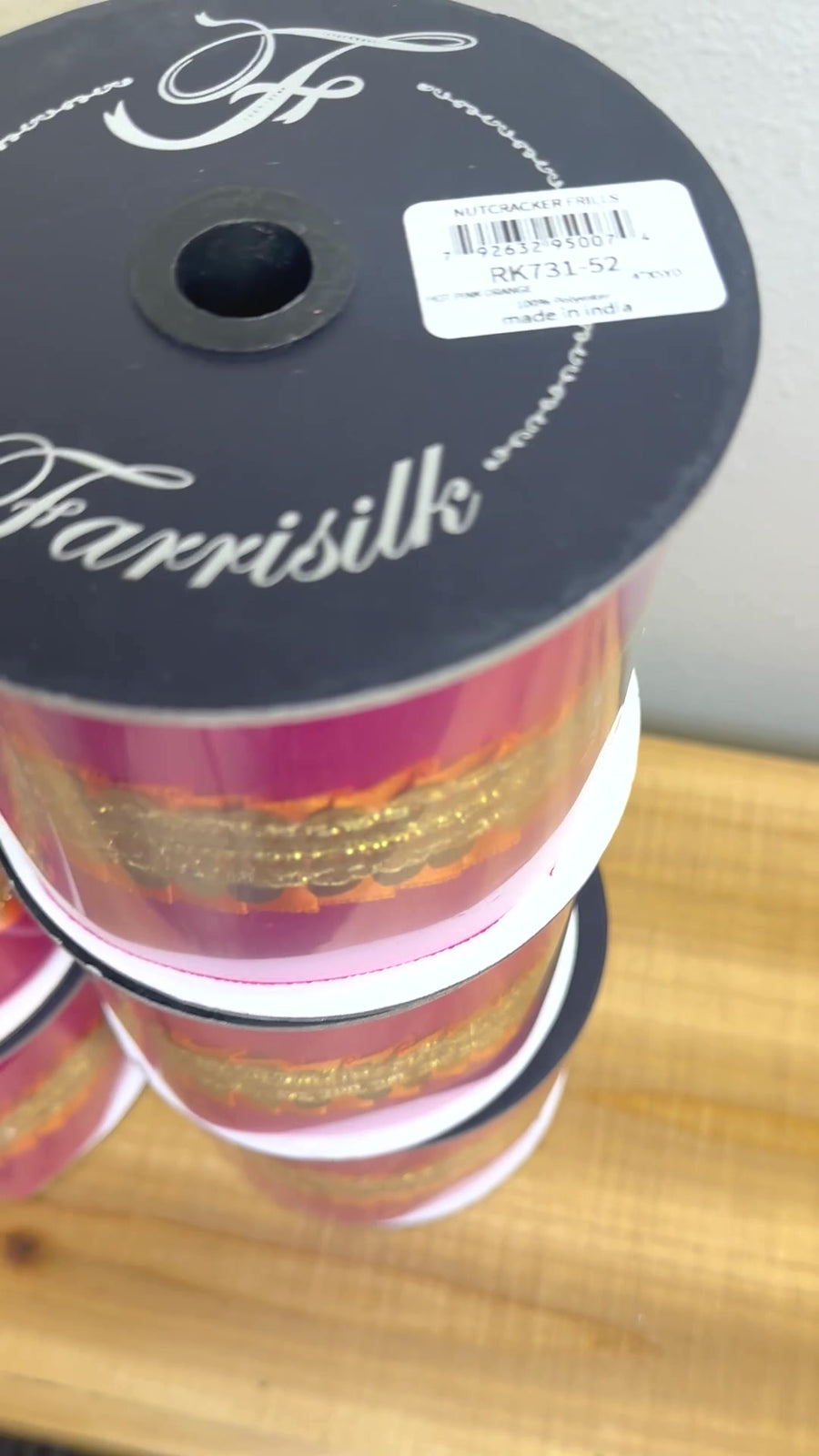 Hot pink and gold sequin ribbon spool close-up