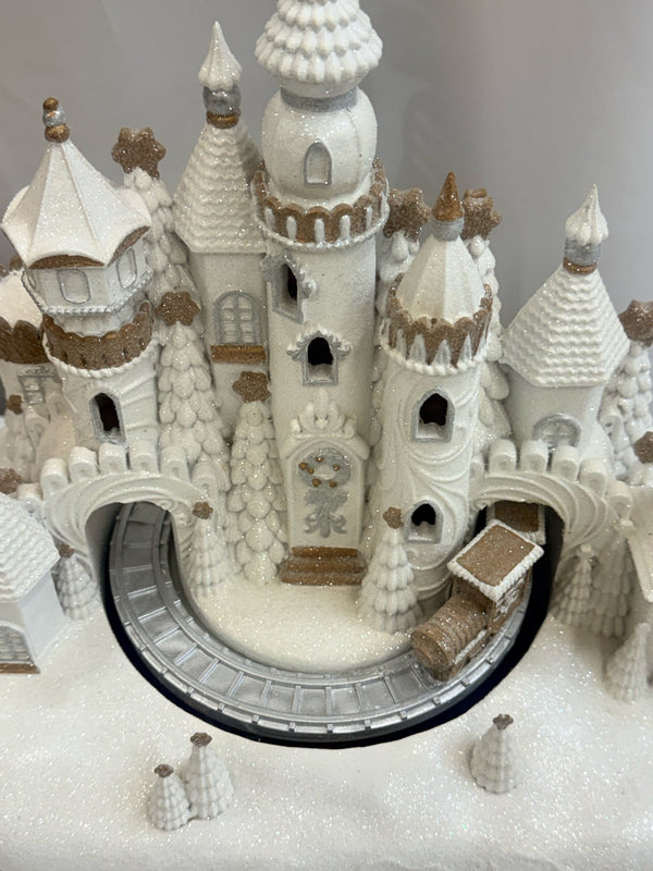 White glitter gingerbread village with moving train