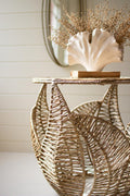 Woven seagrass side table with fern leaf detail styled in a coastal room