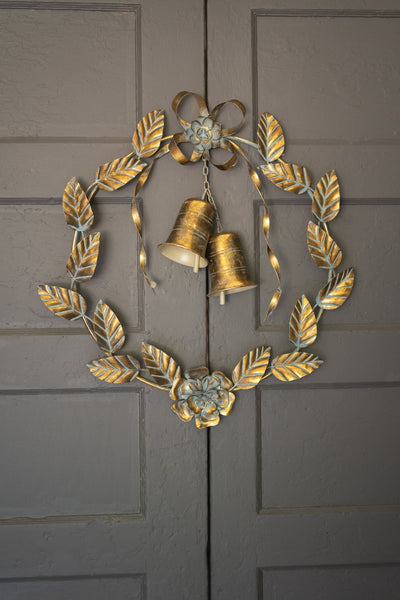 Antique brass Christmas wreath detail showing leaves and bells