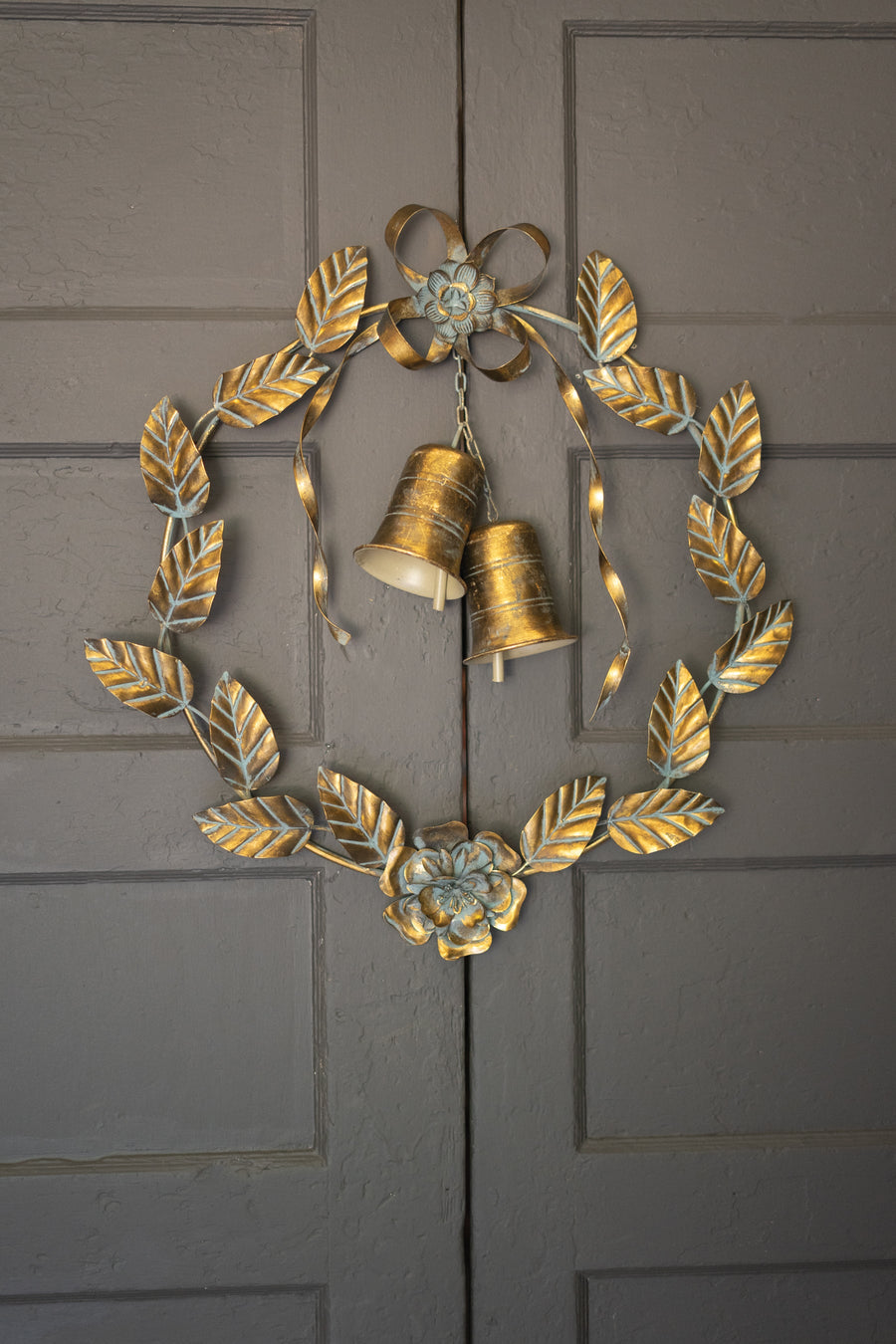 Antique brass Christmas wreath detail showing leaves and bells