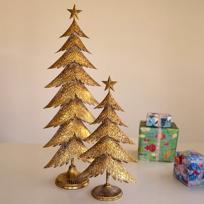 Antique gold Christmas tree set styled by fireplace