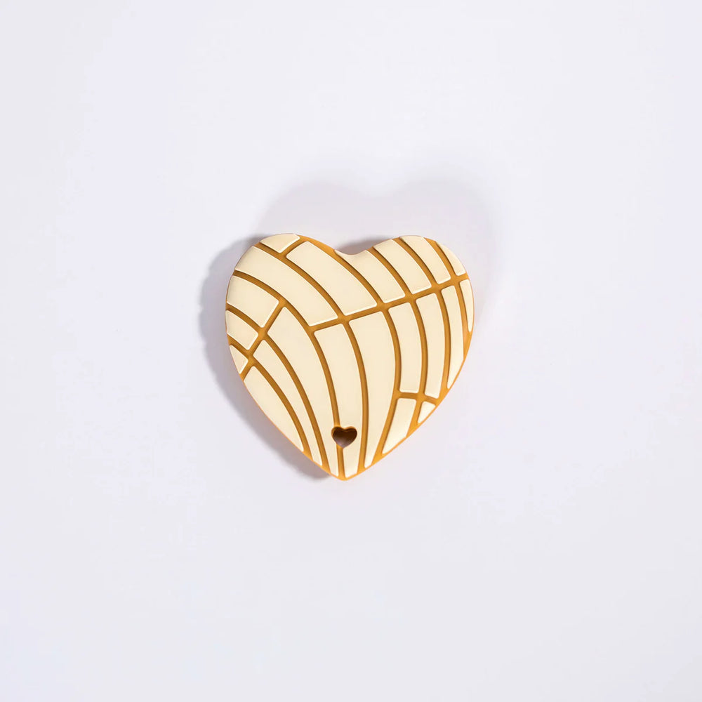 Heart-shaped wooden ornament with wicker pattern on a light purple background