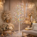 Decorative Easter tree with colorful eggs in a luxurious room with flowers and a sofa.