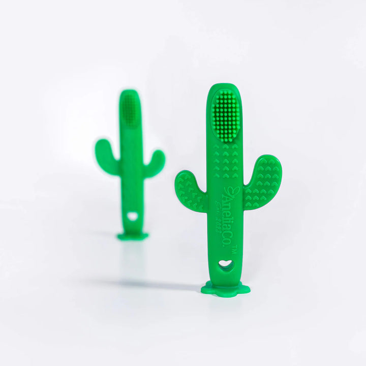 Two green cactus-shaped toothbrushes on a white background
