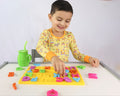 A toddler playing with the Spanish alphabet puzzle