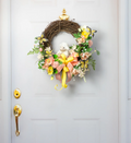 Decorative wreath with flowers and a small dog figurine on a door.