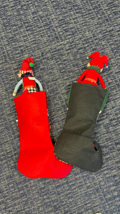 Whimsical elf Christmas stockings set of 2: red felt stocking with plush elf and black jester elf stocking