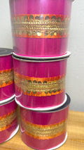 Hot pink and gold sequin wired ribbon spools stacked