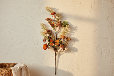 Decorative wall piece with flowers and butterflies on a textured wall