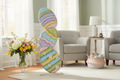 Colorful butterfly-shaped mirror in a living room setting with flowers and eggs.