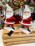 Resin Santas holding ornaments and tree, set of 2